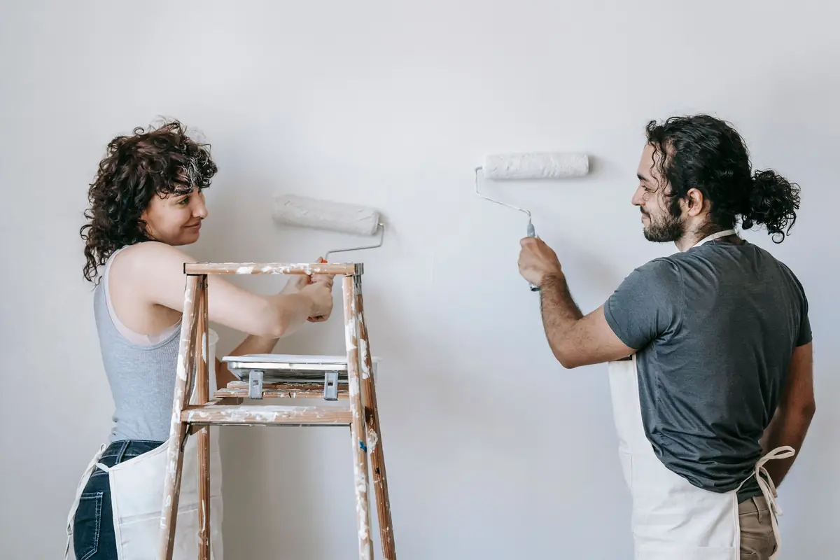 People painting a wall together — painting help in Allentown