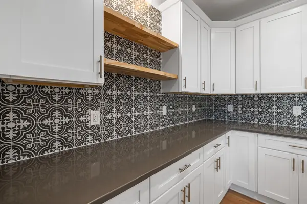 Kitchen with white painted cabinets